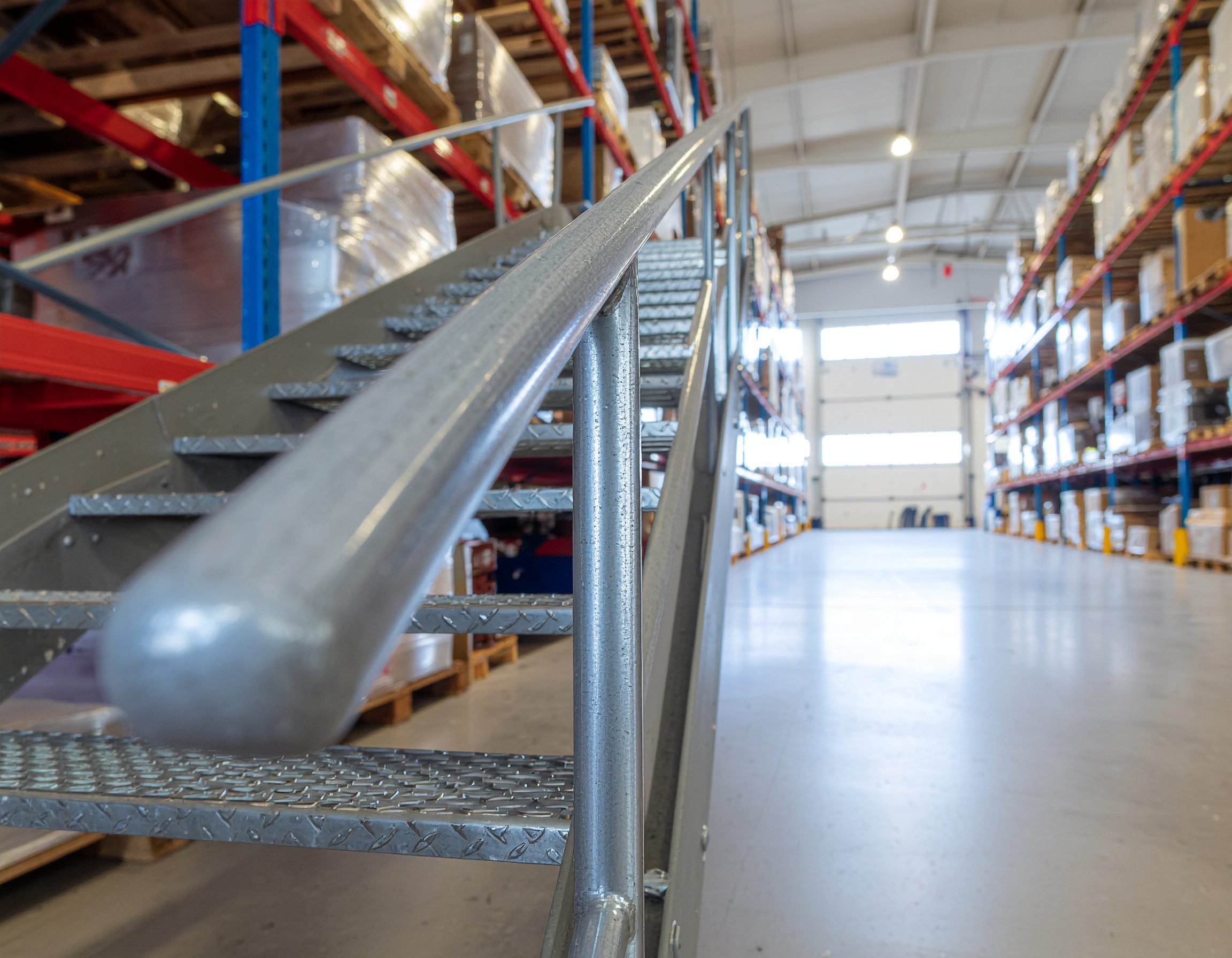 an industrial metal stair railing in a warehouse. Robust design, matte steel finish an industrial metal stair railing in a warehouse. Robust design, matte steel finish