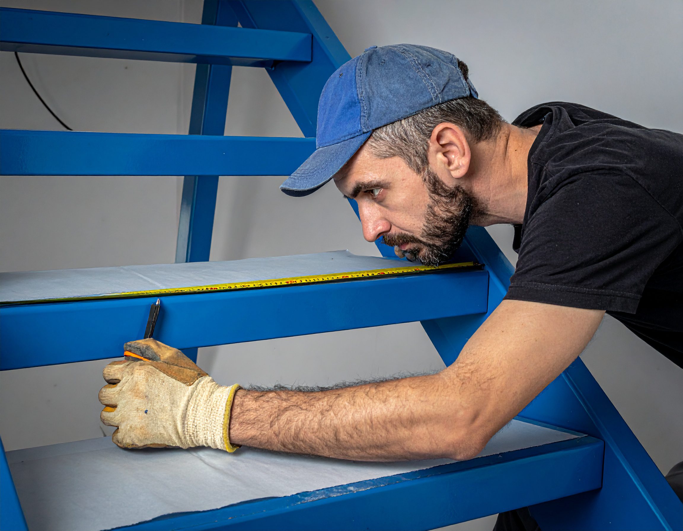 un opérateur prendre le côtes avec un mètre pour la pose d'un escalier en métal un opérateur prendre le côtes avec un mètre pour la pose d'un escalier en métal